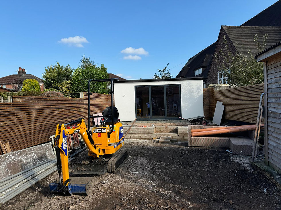 Excavator leveling off new grass area post construction of a double storey extension and garden room