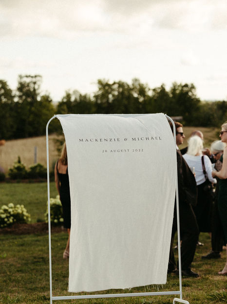 Fabric linen wedding welcome sign blowing in the wind
