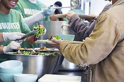 people in a line being served food