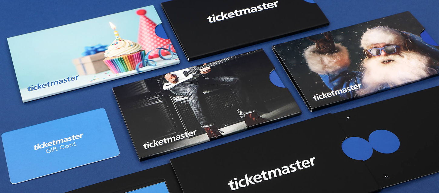 A range of black a
blue sliding cardboard
packaging designs for
Ticketmaster holding a
blue gift card