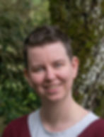 Smiling woman, short hair, outdoors