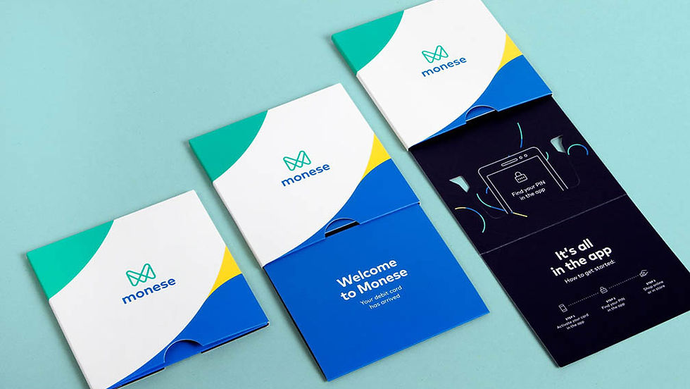 A white blue and green
sliding package with
Monese logo including
an integrated black tray
holding a bank card