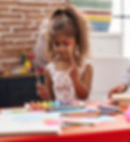 Girl playing xylophone, colorful art supplies