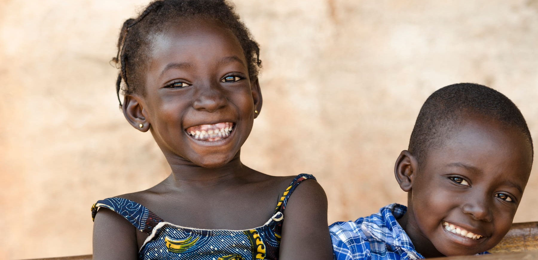 Two smiling African children looking at the camera, happy and joyful