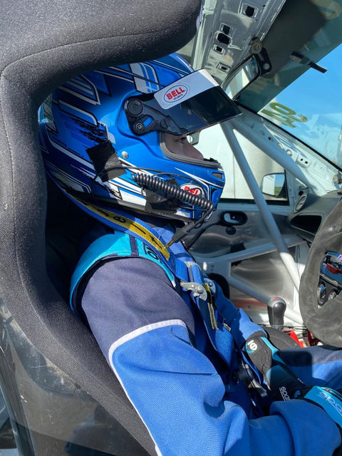 Racer in blue helmet and racing suit