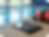 Tablet and rescue tube resting on the deck beside an indoor swimming pool, representing digital near miss reporting and proactive aquatic safety management in a calm, professional facility setting.
