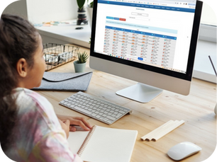 Aquatic professional using facility management software on a desktop computer to review staff schedules and take notes.