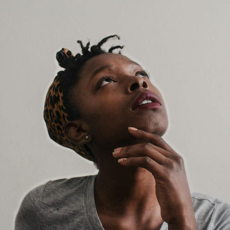 Reflective woman looking upward, representing subtle signs of unresolved trauma, overwhelm, and emotional burden in high-functioning adults