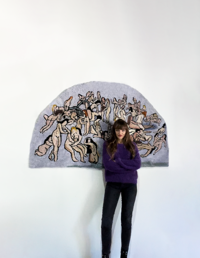 French artist Eva Ostrowska in front of her tapestry .