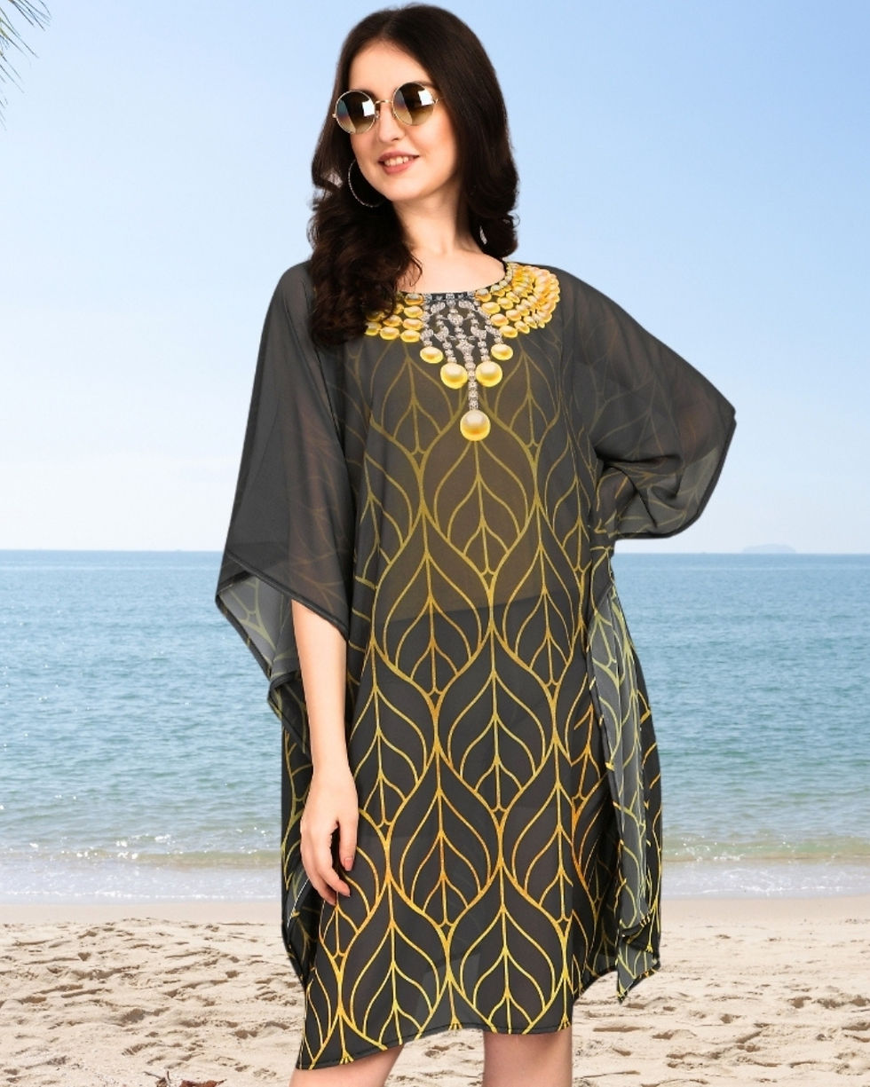 Close-up of dark gray short kaftan with yellow leaf pattern and decorative neckline.