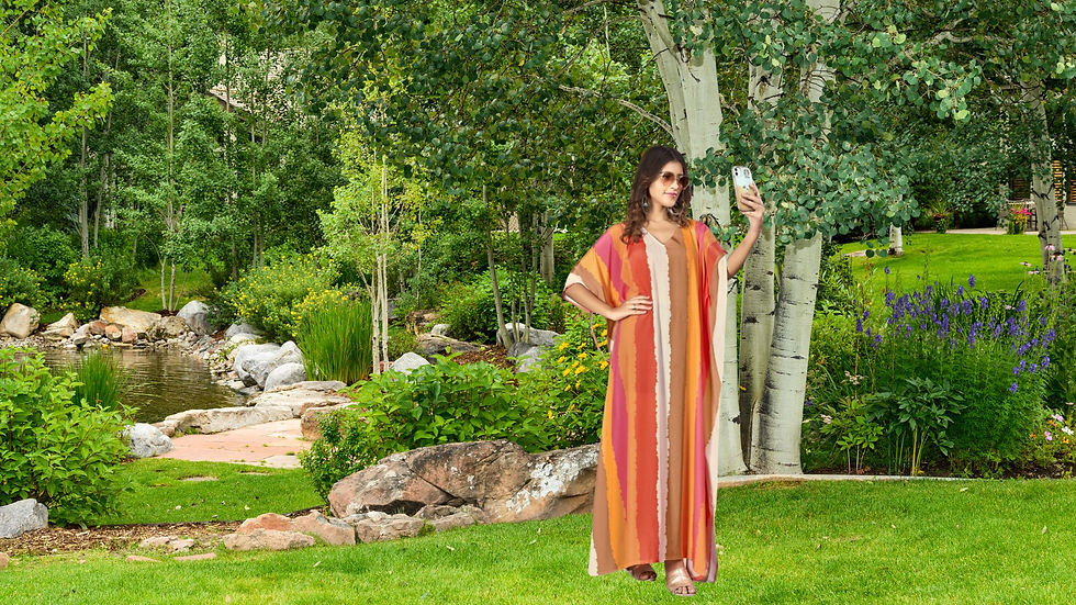 a girl in a multicolor kaftan taking a selfie.