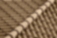 A close-up view of brown, curved clay roof tiles, neatly arranged in an overlapping pattern