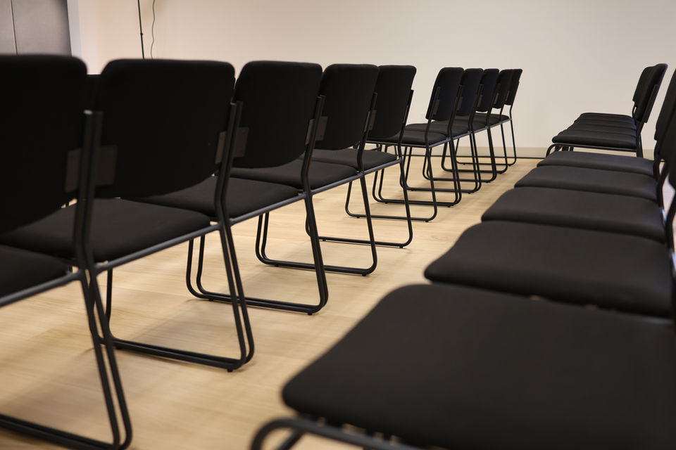 Wide-angle view of the recital hall with flexible seating and bright acoustically tuned walls.