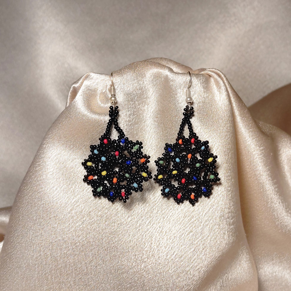 Thumbnail: Black beaded floral earrings with colorful accents on silk