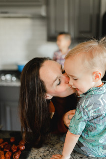 Mother and son kisses