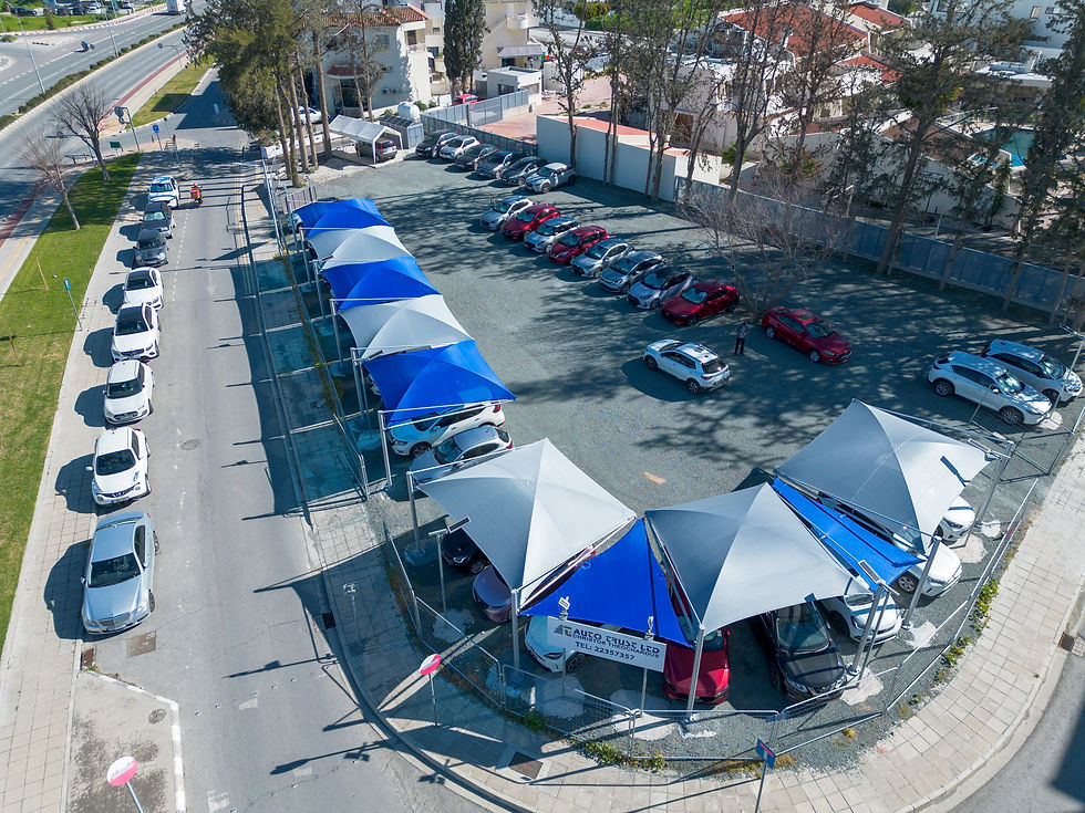 Zeus carports Cyprus, car dealership carports, vehicle shade structures, commercial carports Nicosia, Auto Trust dealership, silver carport modules, royal blue carports, parking shade solutions Cyprus, automotive shade structures, weather-resistant carports, premium carports Cyprus, dealership canopy systems.