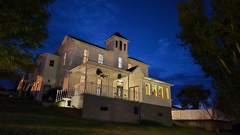 Evening photo of the home and property