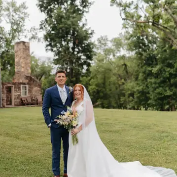 The Campbell Farm, Springfield, WV Bride and Groom in front of stone Manor House