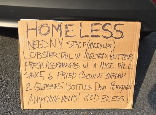JD6_a photo of a homeless man's cardboard box sign