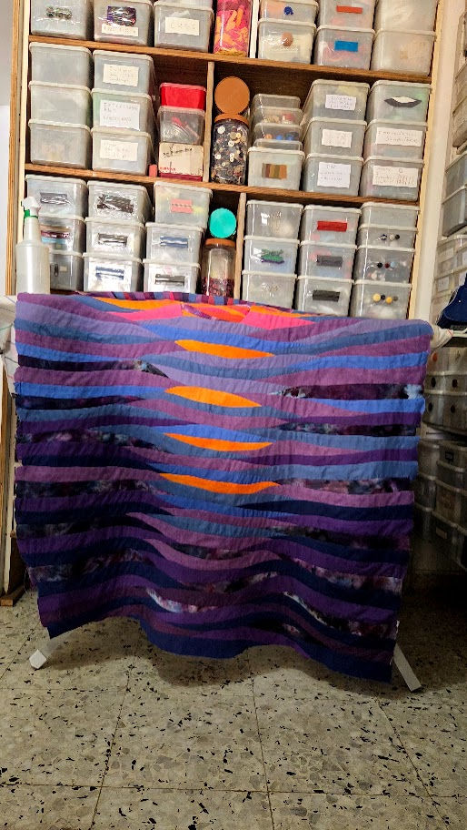 wave sunset quilt on an ironing board