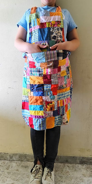 girl wearing a patchwork apron