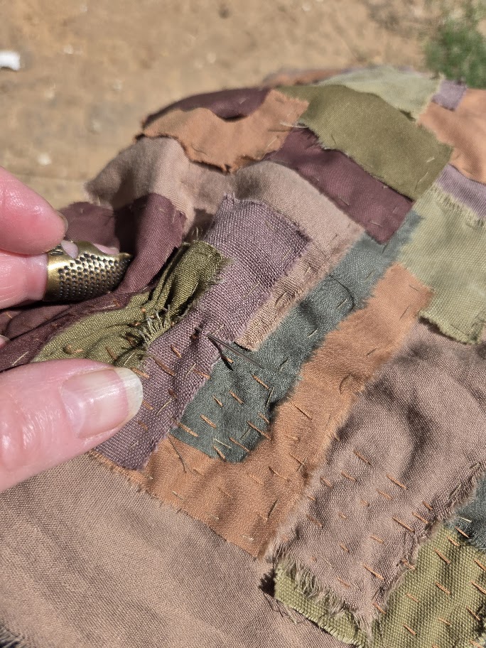 sitting in the sun and handsewing patchwork fabric