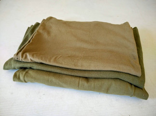 3 t shirts folded on a table