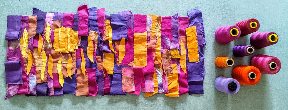 sunset colored fabrics and threads on a table