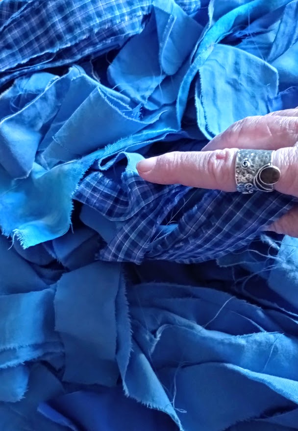 hand holding blue fabric strips