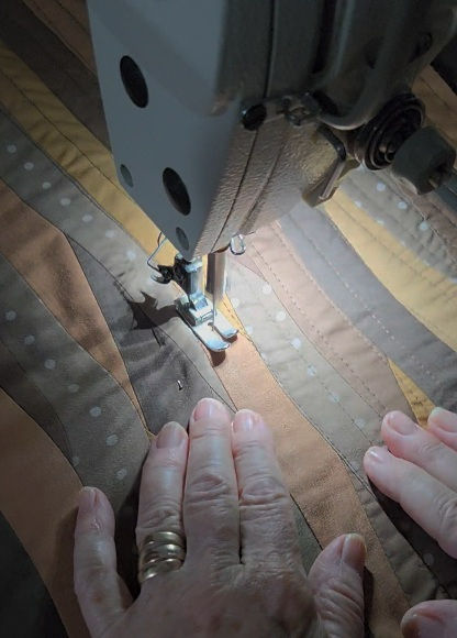 sewing a patchwork quilt