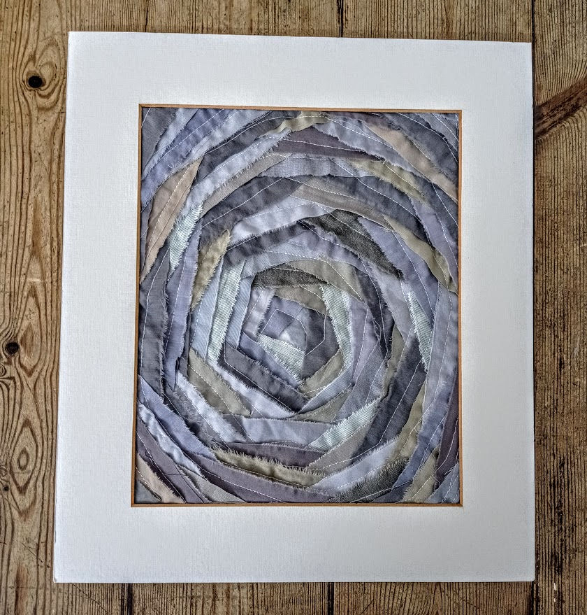 Thumbnail: grey framed spiral fabric patchwork art
