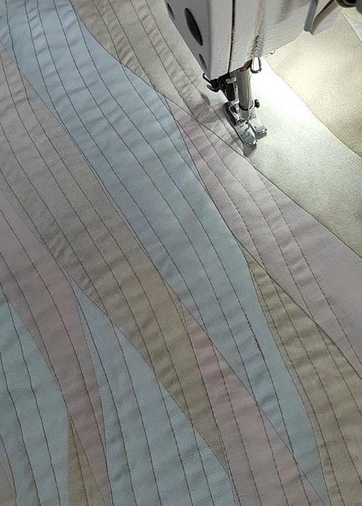Thumbnail: sewing machine sewing on striped background fabirc