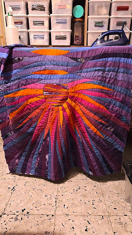ironing the last strips on the wave sunset quilt