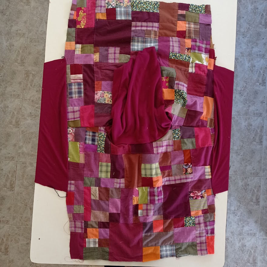 shirt laid out with sleeves pinned to the armhole