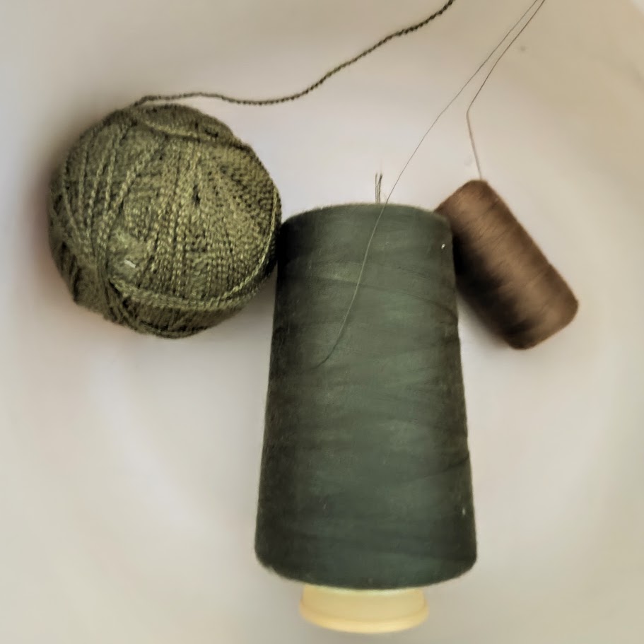 3 camo colored spools of thread