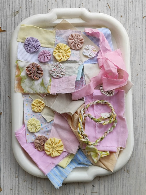 pink and pastel fabrics laid out on a board