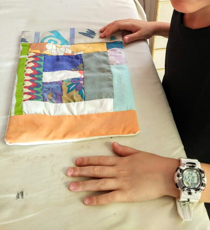 Thumbnail: girl next to summer colored patchwork pillow