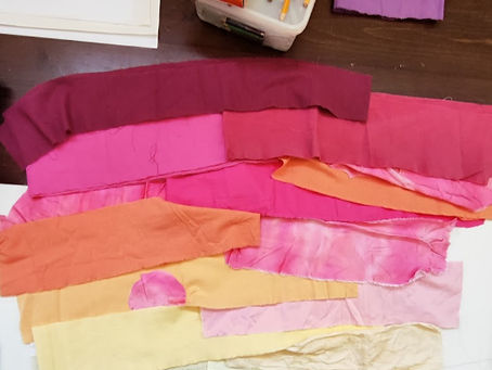fabric strips in sunrise colors placed on a table