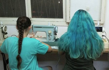 2 girls sewing on sewing machines