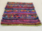 Thumbnail: textured fabric art piece lying on a table