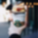 a starbucks cup with an egg breakfast sandwich on top.