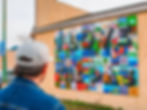 Man looking at a mural in The Pas