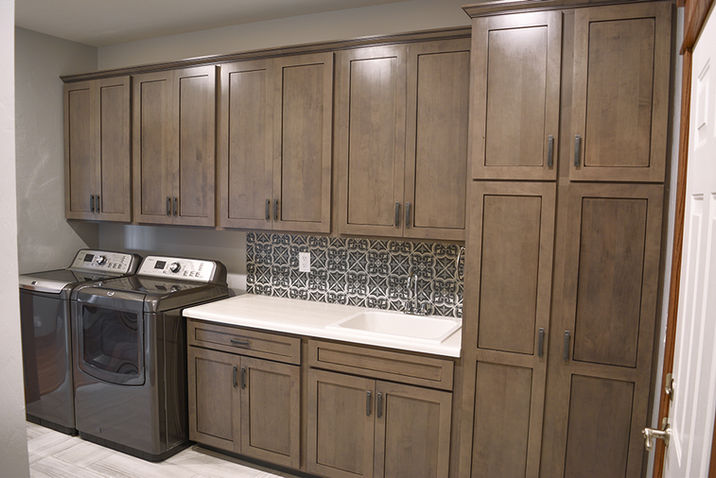 Laundry Room with Maple Cabinets, white countertop, and utility sink.