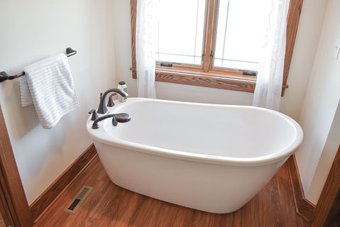Maax sax freestanding tub with mounted faucets.