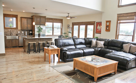 Modern home with open concept living area and kitchen layout featuring lots of windows for natural light.