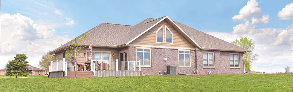 Cottonwood modular home with custom brick siding. Back deck area and windows to living room shown from the exterior.