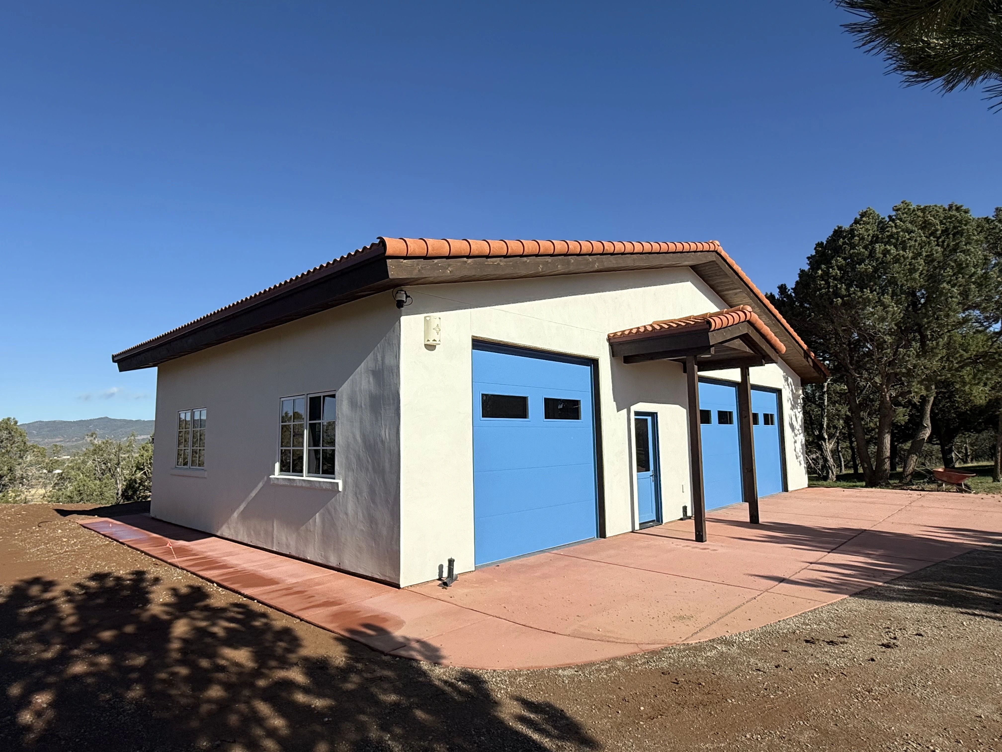 Ranch storage building with two blue garage doors