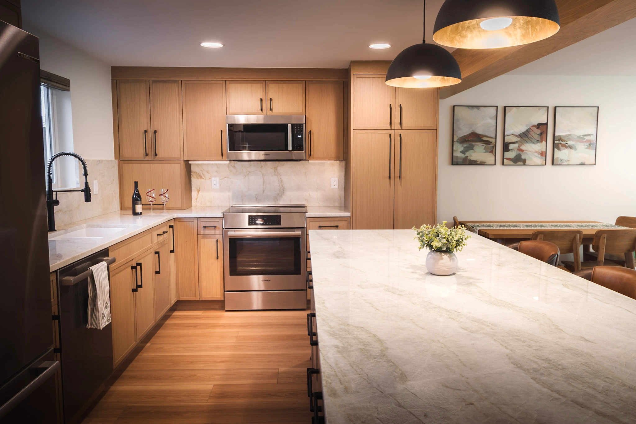 Modern ranch kitchen with wood cabinets, steel appliances, island