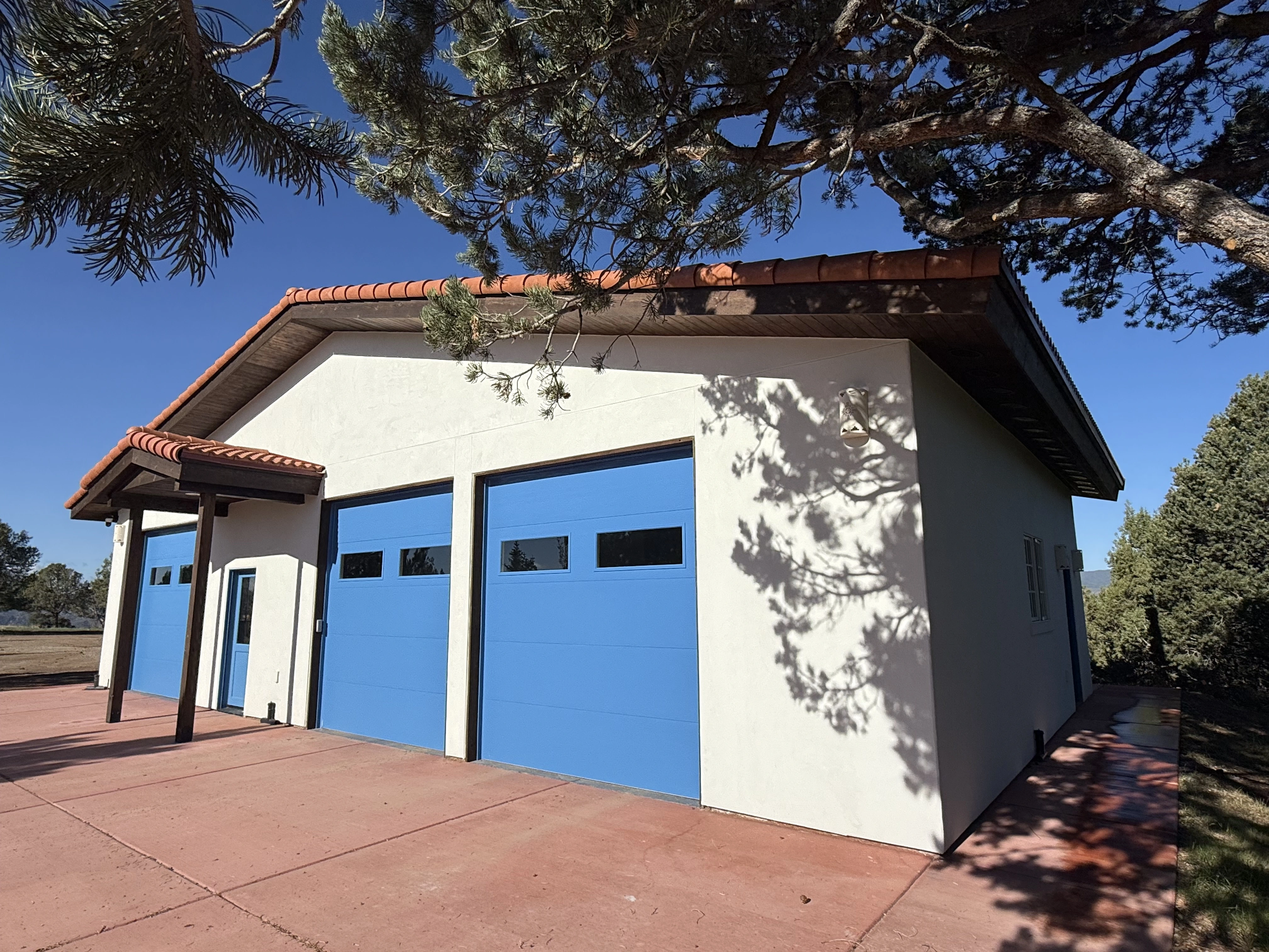 White storage building with blue garage doors