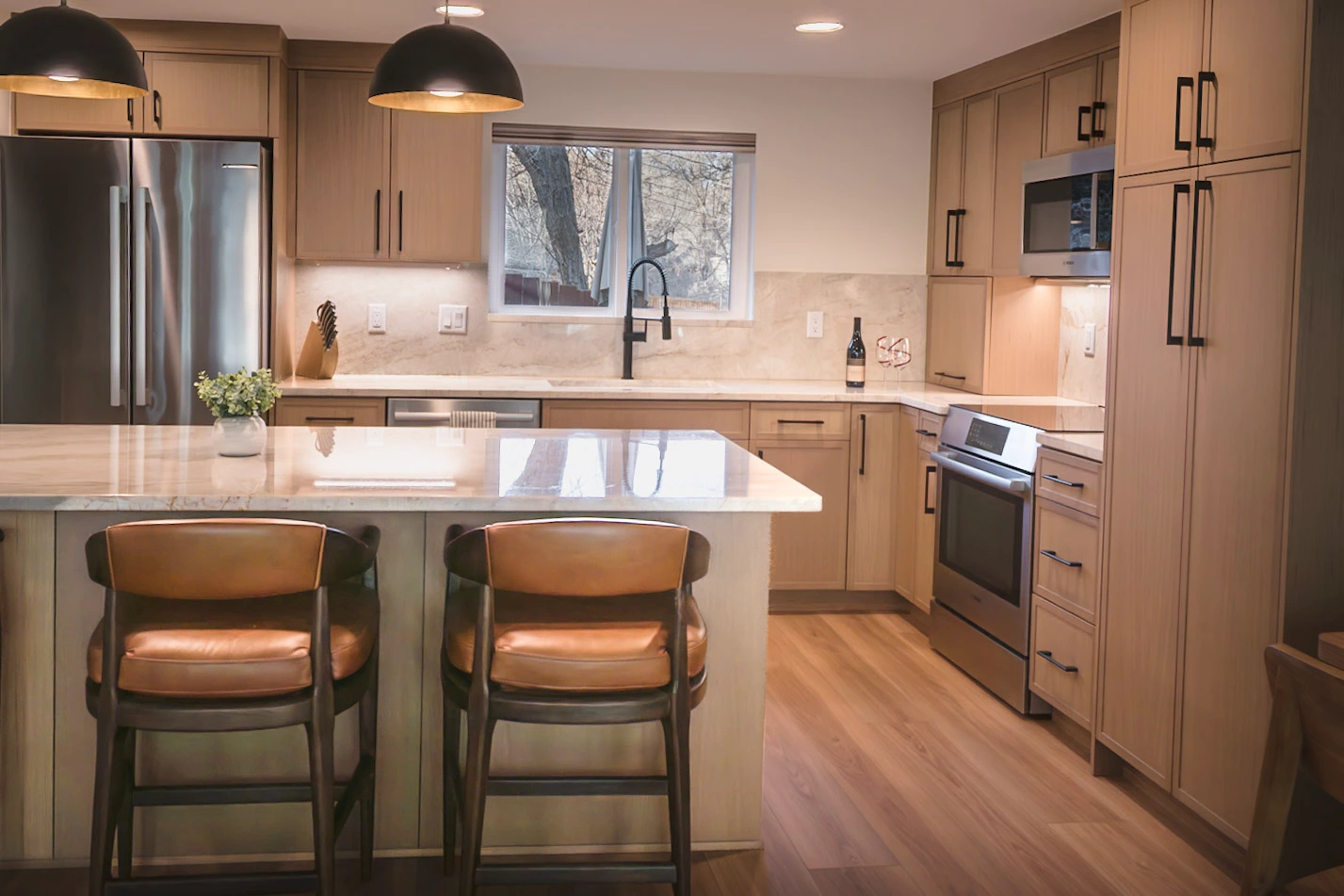 Modern kitchen with island, wood cabinets, and steel appliances